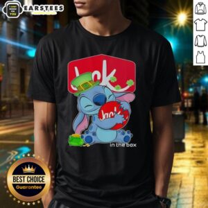 Alt Text: Cute Stitch hugging Jack In The Box logo on a Happy St. Patrick's Day T-Shirt, perfect for festive celebrations.