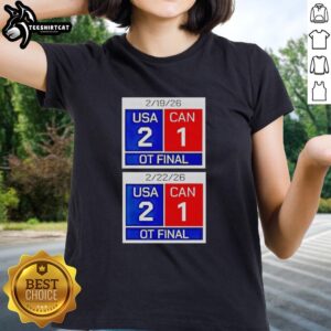Alt Text: Premium American Hockey Scoreboard: USA 2, Canada 1 OT Final 2026 on a stylish ladies tee.