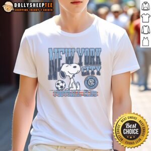 Alt Text: Top Peanuts Snoopy X New York City FC T-Shirt featuring Snoopy in soccer gear with NYC skyline background.