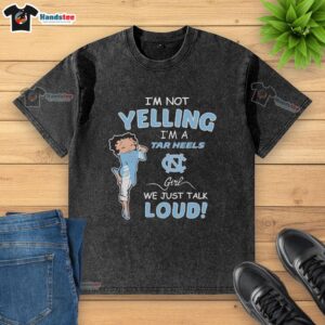 Alt Text: North Carolina Tar Heels girl in a washed t-shirt, playfully expressing pride with 'I'm not yelling, we just talk loud.'