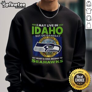 Alt Text: Cozy sweatshirt featuring I May Live In Idaho But On Gameday My Heart And Soul Belong To Seahawks design.
