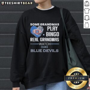 Grandmas in Duke Blue Devils sweatshirt enjoy bingo night, celebrating fun and sports together.