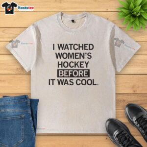 Vintage washed t-shirt with 'I Watched Women's Hockey Before It Was Cool' slogan, perfect for hockey fans and casual wear.