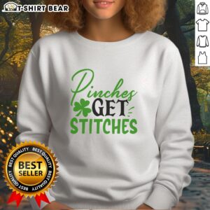 Official Pinches Get Stitches Irish sweatshirt featuring a bold graphic design perfect for St. Patrick's Day celebrations.