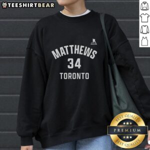 Alt Text: Auston Matthews 34 Toronto Maple Leafs sweatshirt featuring name and number design for fans.