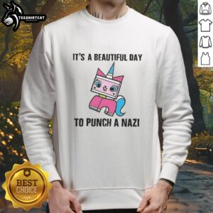 Original It's A Beautiful Day To Punch A Nazi Princess Unikitty Sweatshirt featuring colorful graphic design and cozy fit.