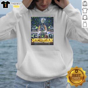 Oluwatimi Barner celebrates with the trophy in a Michigan hoodie, showcasing pride for the Seattle Seahawks.