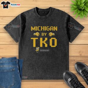 Alt Text: Official Michigan By TKO Jon Rothstein washed t-shirt featuring bold graphics and a comfortable fit for fans.
