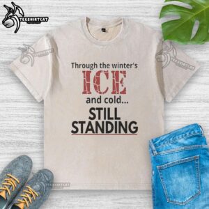 Worn washed t-shirt displayed on snowy Minneapolis street, showcasing resilience through winter's ice and cold.