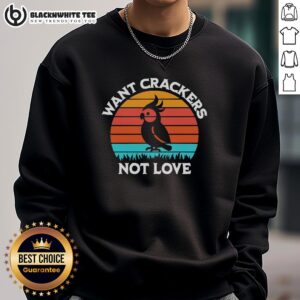 Hot cockatiel shadow graphic on retro sweatshirt, playfully stating 'Want Crackers Not Love' against a sunset backdrop.