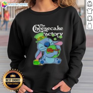 Alt Text: Cute Stitch hugging The Cheesecake Factory logo on a Happy St. Patrick's Day sweatshirt design.
