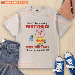 Funny pig in a washed T-shirt, expressing dislike for pantyhose, humorously stating every fart blows off its slippers.