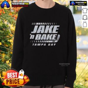 Alt Text: Jake Guentzel wearing a stylish 'N' Bake sweatshirt while cheering for the Tampa Bay Lightning in hockey.