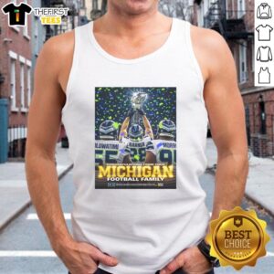 NICE Oluwatimi Barner Morr celebrating with trophy in Seattle Seahawks gear, wearing Michigan tank top. Congratulations!