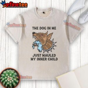 Premium 'The Dog In Me Just Mauled My Inner Child' washed t-shirt displayed on a wooden background, showcasing unique design.
