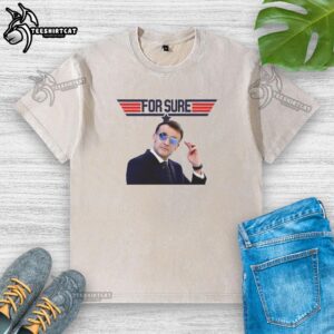 Emmanuel Macron in a washed t-shirt featuring the Top Gun logo, showcasing a casual style and political flair.