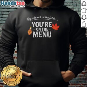 Original 'If You're Not At The Table, You're On The Menu' hoodie in stylish design, perfect for casual wear.