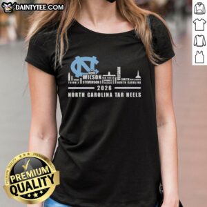 Alt Text: 2026 North Carolina Tar Heels ladies tee featuring city skyline design and team names, perfect for fans.