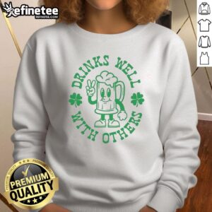 Green St. Patrick's Day sweatshirt featuring 'Official Drinks Well With Others' design, perfect for festive celebrations.