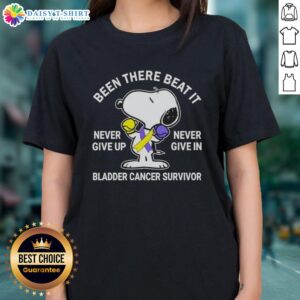 Alt Text: Snoopy graphic on ladies tee with 'Never Give Up Never Give In' for bladder cancer survivors, promoting resilience.