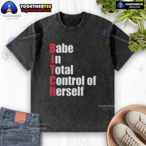 Alt Text: Stylish woman wearing a washed red t-shirt with Top Babe In Total Control Of Herself graphic text, exuding confidence.