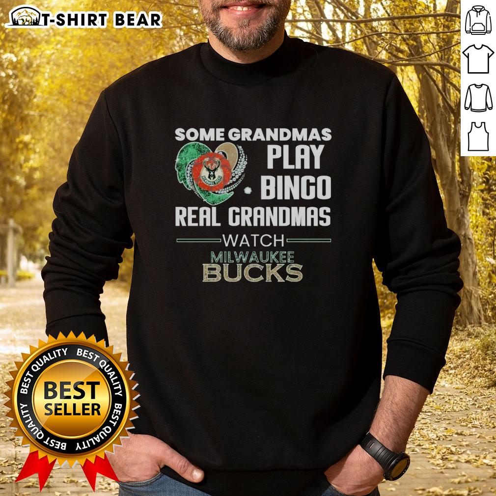 Awesome Some Grandmas Play Bingo Real Grandmas Watch Milwaukee Bucks Sweatshirt Grandmas enjoying bingo in Milwaukee Bucks sweatshirt, showcasing fun and team spirit in a cozy setting.