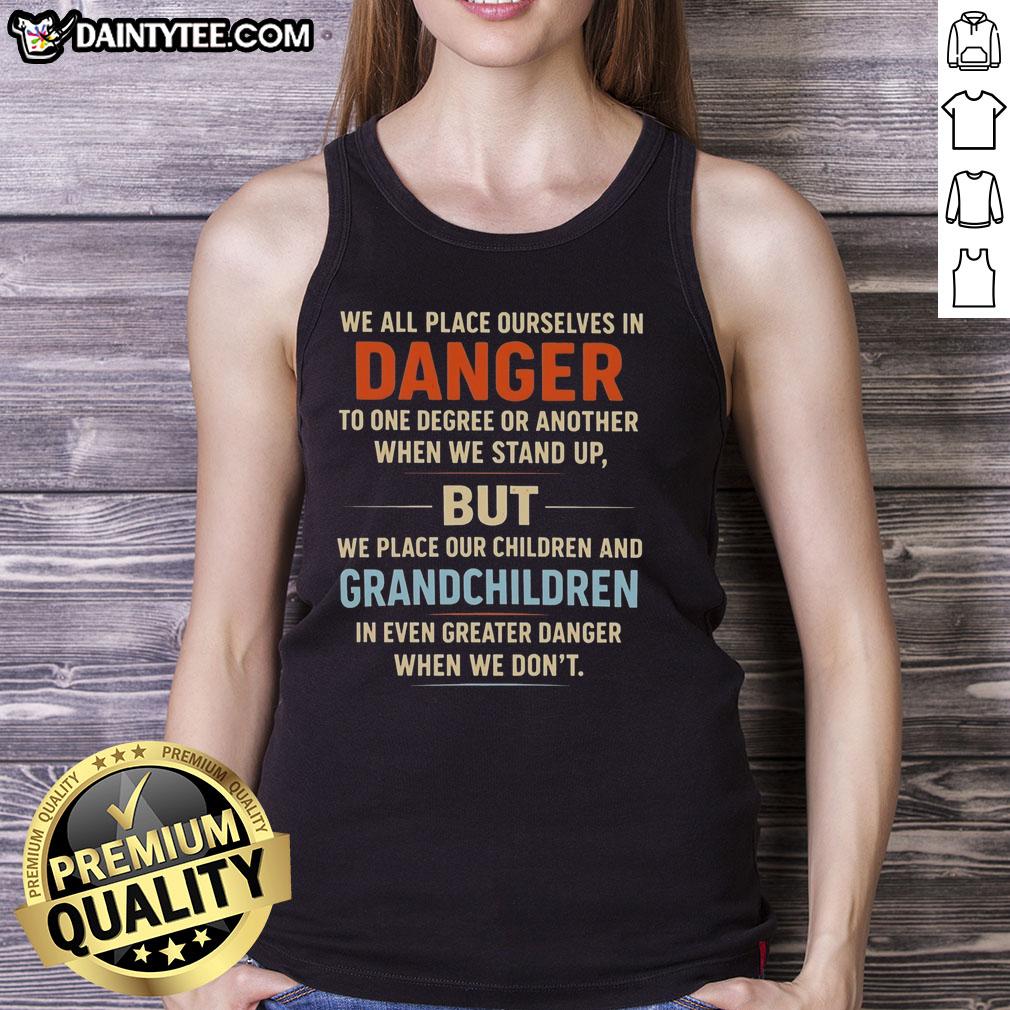 awesome-we-all-place-ourselves-in-danger-to-one-degree-or-another-when-we-stand-up-tank-top Person wearing an 'Awesome We All Place Ourselves In Danger' tank top standing confidently outdoors.