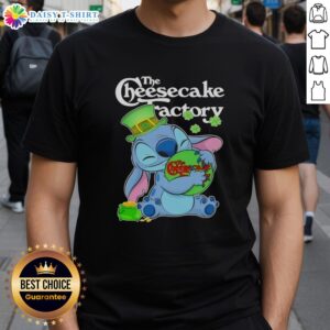 Adorable Stitch hugging The Cheesecake Factory logo on a Happy St. Patrick's Day T-shirt, perfect for festive celebrations.