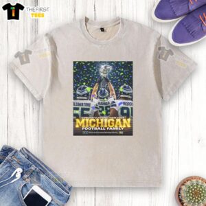 Alt Text: Nice Oluwatimi Barner Morr of the Seattle Seahawks holding a trophy, wearing a Michigan washed t-shirt, celebrating victory.