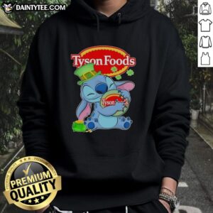 Alt Text: Model wearing a St. Patrick's hoodie featuring the Tyson Foods logo and Pretty Stitch design for festive style.