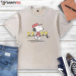Alt Text: Cute Peanuts Snoopy and Woodstock friends graphic on a washed golf t-shirt, perfect for casual wear and fans.