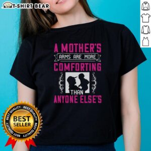 Lady wearing a 'Nice A Mother's Arms Are More Comforting Than Anyone Else' tee, showcasing warmth and love in a cozy setting.