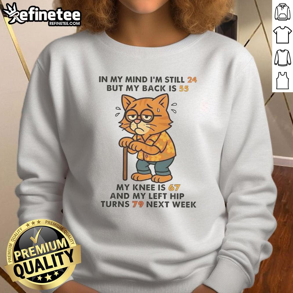 funny-in-my-mind-im-still-24-but-my-back-is-55-my-knee-is-67-and-my-left-hip-turns-79-next-week-cat-sweatshirt Funny cat sweatshirt design: 'In my mind I'm still 24, but my back is 55' showcasing humor about aging.