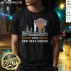 2026 New York Knicks skyline T-shirt showcasing team names and iconic city landmarks in vibrant colors.