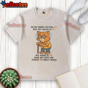 Funny cat washed t-shirt reading 'I'm still 24, but my body feels 55' humorously depicting aging and fitness struggles.