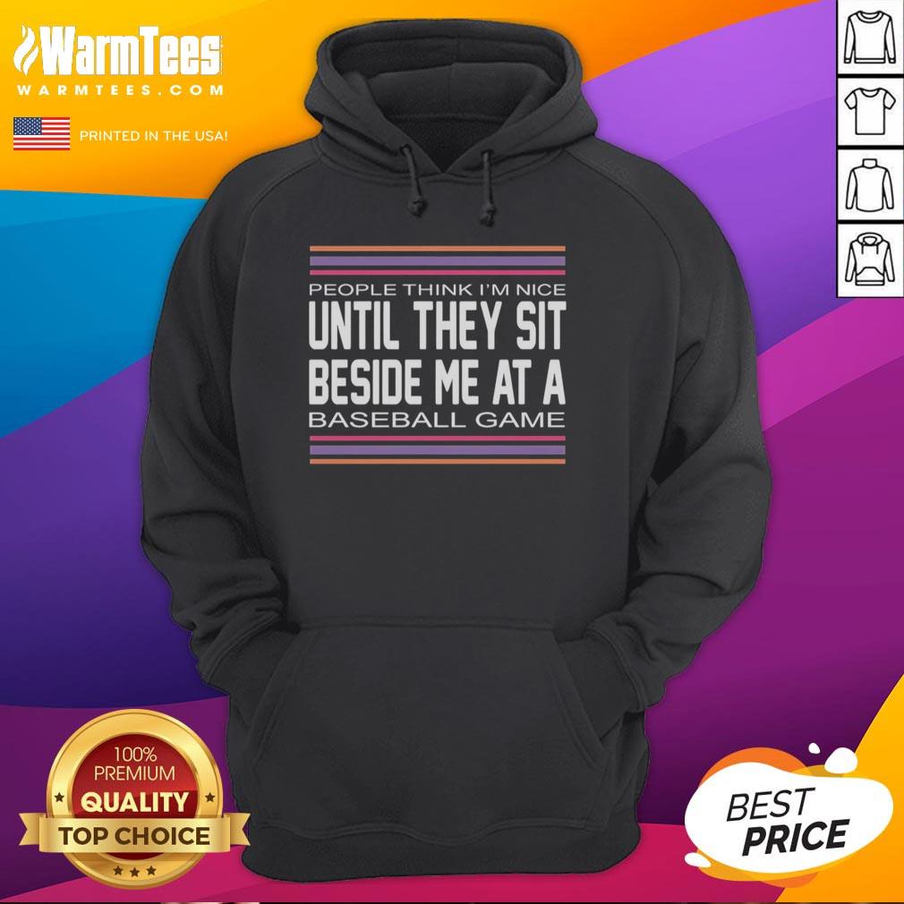 hot-people-think-im-nice-until-they-sit-beside-me-at-a-baseball-game-hoodie Person wearing 'Hot People Think I'm Nice' hoodie at a baseball game, showcasing humor and style in a lively atmosphere.