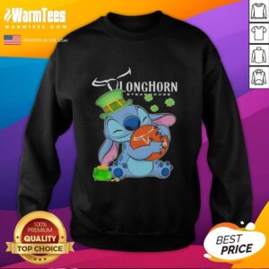Alt Text: Cute Stitch hugging the Texas Longhorn Steakhouse logo on a Happy St. Patrick's Day sweatshirt design.