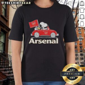 Alt Text: Snoopy and Woodstock driving an Arsenal red car, raising a flag, featured on a ladies tee shirt design.