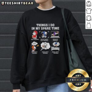 Alt Text: Cozy 'Pretty Things I Do In My Spare Time' Snoopy sweatshirt featuring Snoopy playing football, perfect for casual wear.