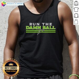 Kenneth Walker III in Seattle Seahawks signature tank top, showcasing his 'Run The Damn Ball' motto on a vibrant background.
