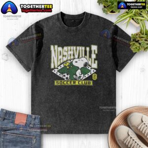 Awesome Peanuts Snoopy X Nashville SC washed t-shirt featuring a vibrant graphic of Snoopy in team colors.