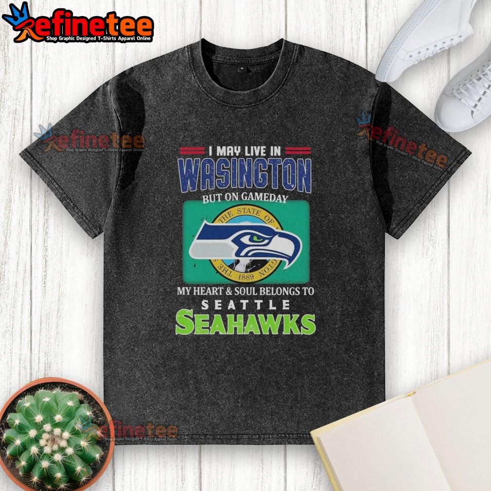 official-i-may-live-in-washington-but-on-gameday-my-heart-soul-belongs-to-seahawks-washed-t-shirt Official I May Live In Washington But On Gameday My Heart Soul Belongs To Seahawks washed t-shirt displayed on a hanger.
