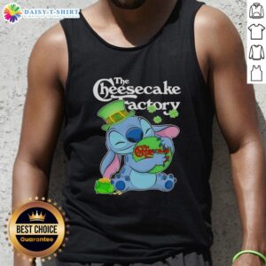 Alt Text: Cute Stitch hugging The Cheesecake Factory logo on a Happy St. Patrick's Day tank top, perfect for festive celebrations.