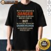 Premium 'We All Place Ourselves In Danger' T-Shirt design featuring bold text, perfect for expressive fashion lovers.