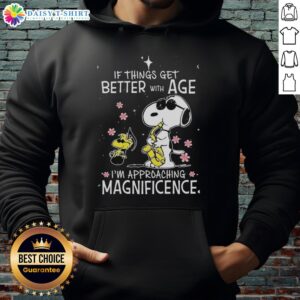 Alt Text: Snoopy and Woodstock hoodie with 'If Things Get Better With Age, Im Approaching Magnificence' slogan.