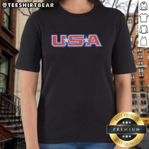 Alt Text: Owen Shroyer wearing a USA ladies tee, showcasing patriotism and style in a vibrant outdoor setting.