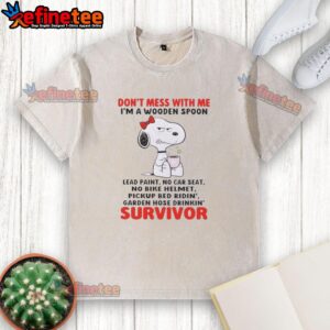 Snoopy graphic t-shirt reading 'Don't Mess With Me I'm A Wooden Spoon Survivor' with playful design and vibrant colors.
