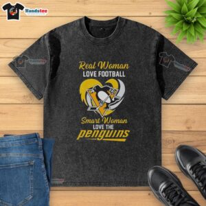 Pretty real woman in a heart washed t-shirt, showcasing her love for football and the Pittsburgh Penguins.