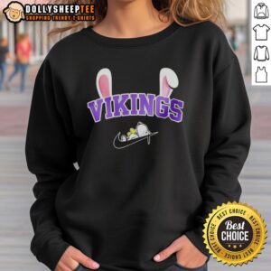 Official Minnesota Vikings X Snoopy Happy Easter Sweatshirt featuring festive design and team logo for fans.