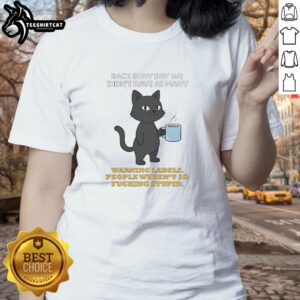 Alt Text: Original cat-themed ladies tee featuring a humorous quote about warning labels and common sense from the past.